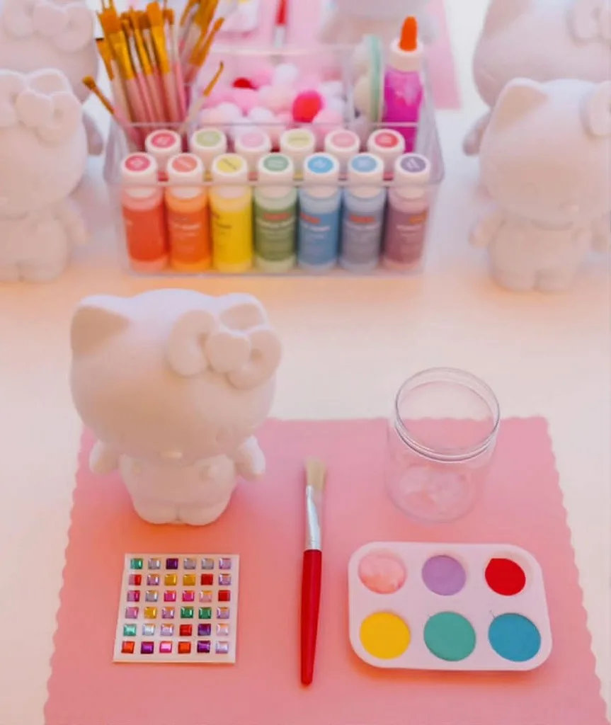 Paints, gems and figurines for a plaster painting party